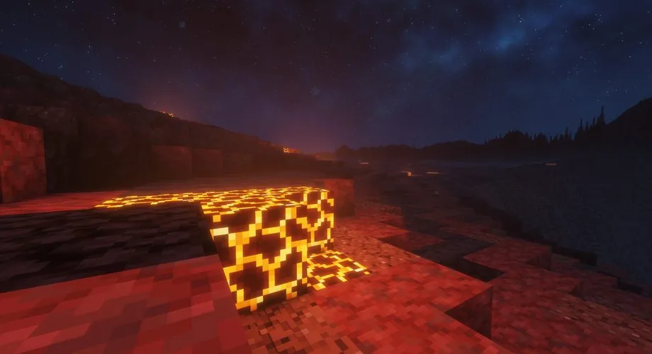 Glowing volcanic rock beside the water under a starry sky in Olzhar