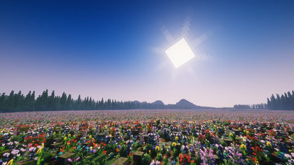 A vast meadow of colourful flowers reaching towards distant forested hills